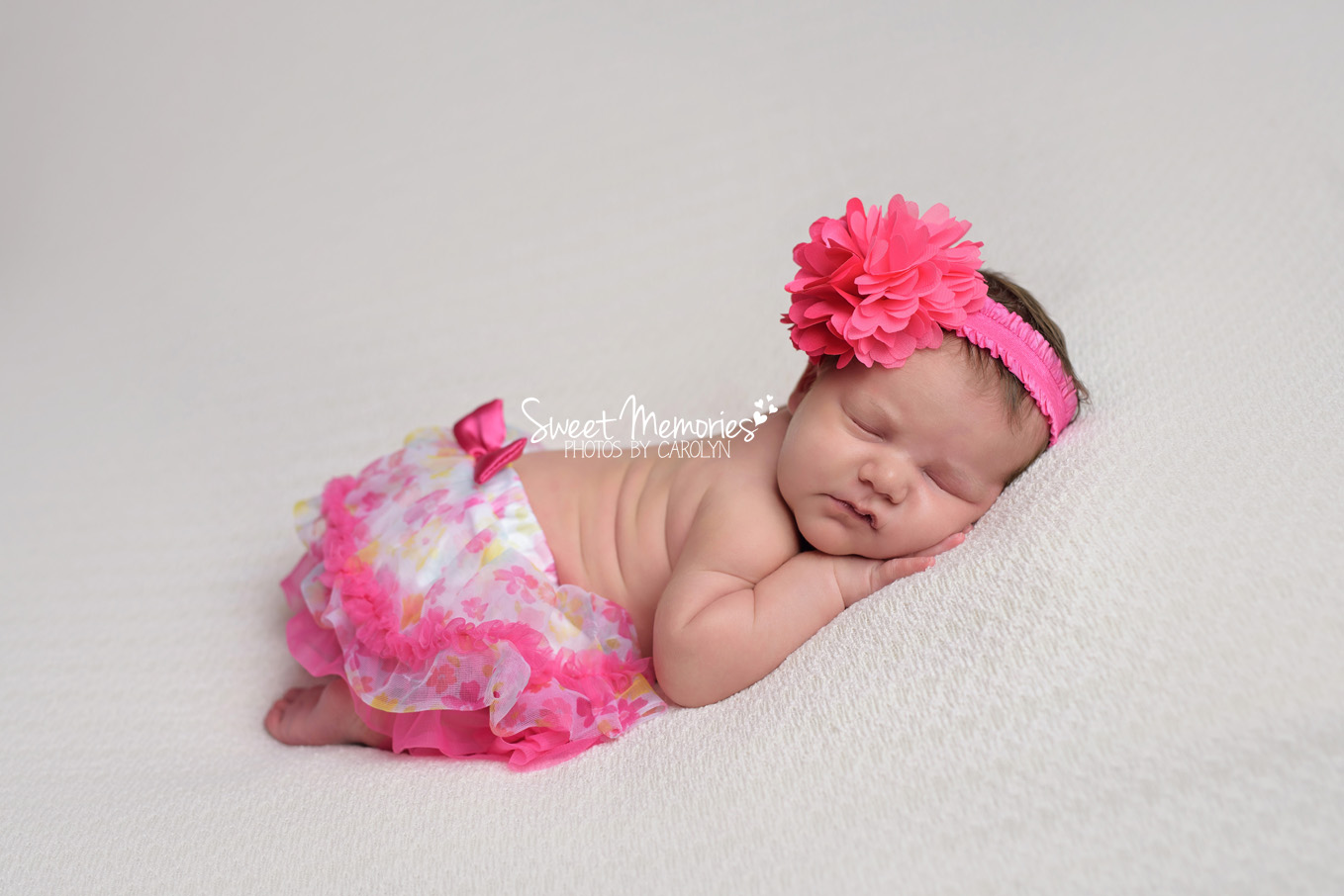 Newborn girl in floral skirt
