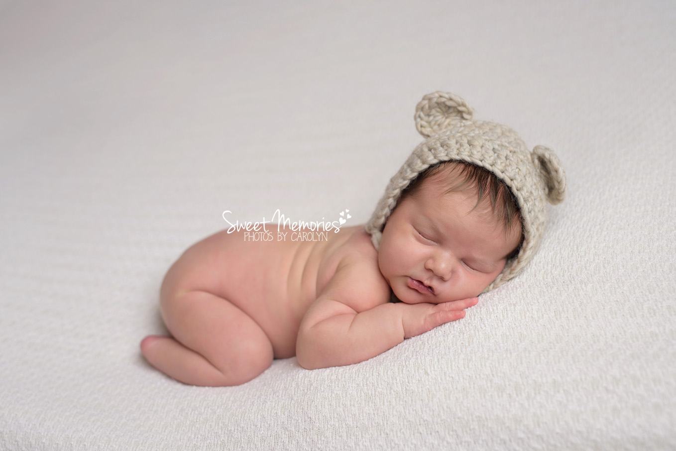 Newborn in teddy bear hat