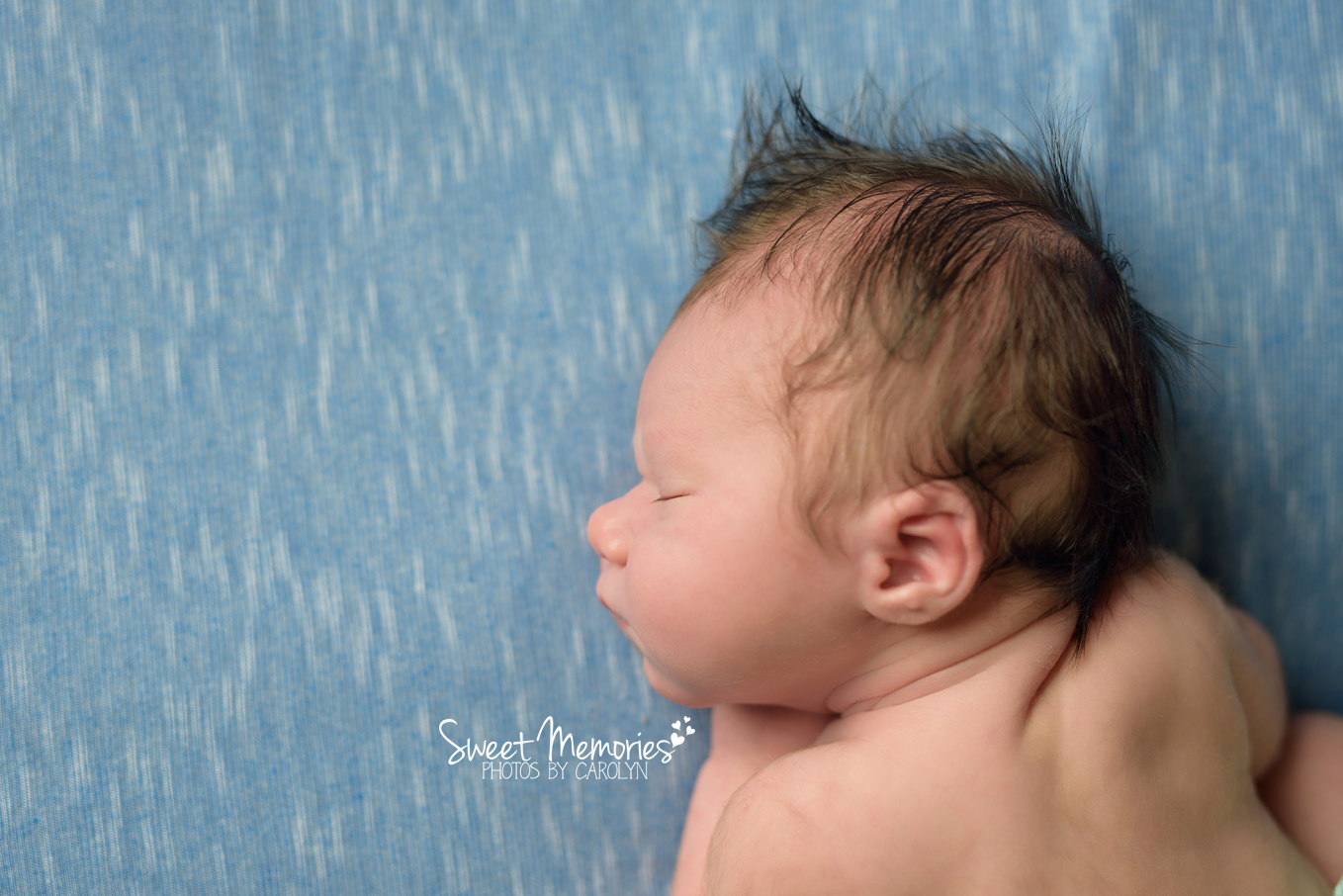 newborn boy on blue with mohawk