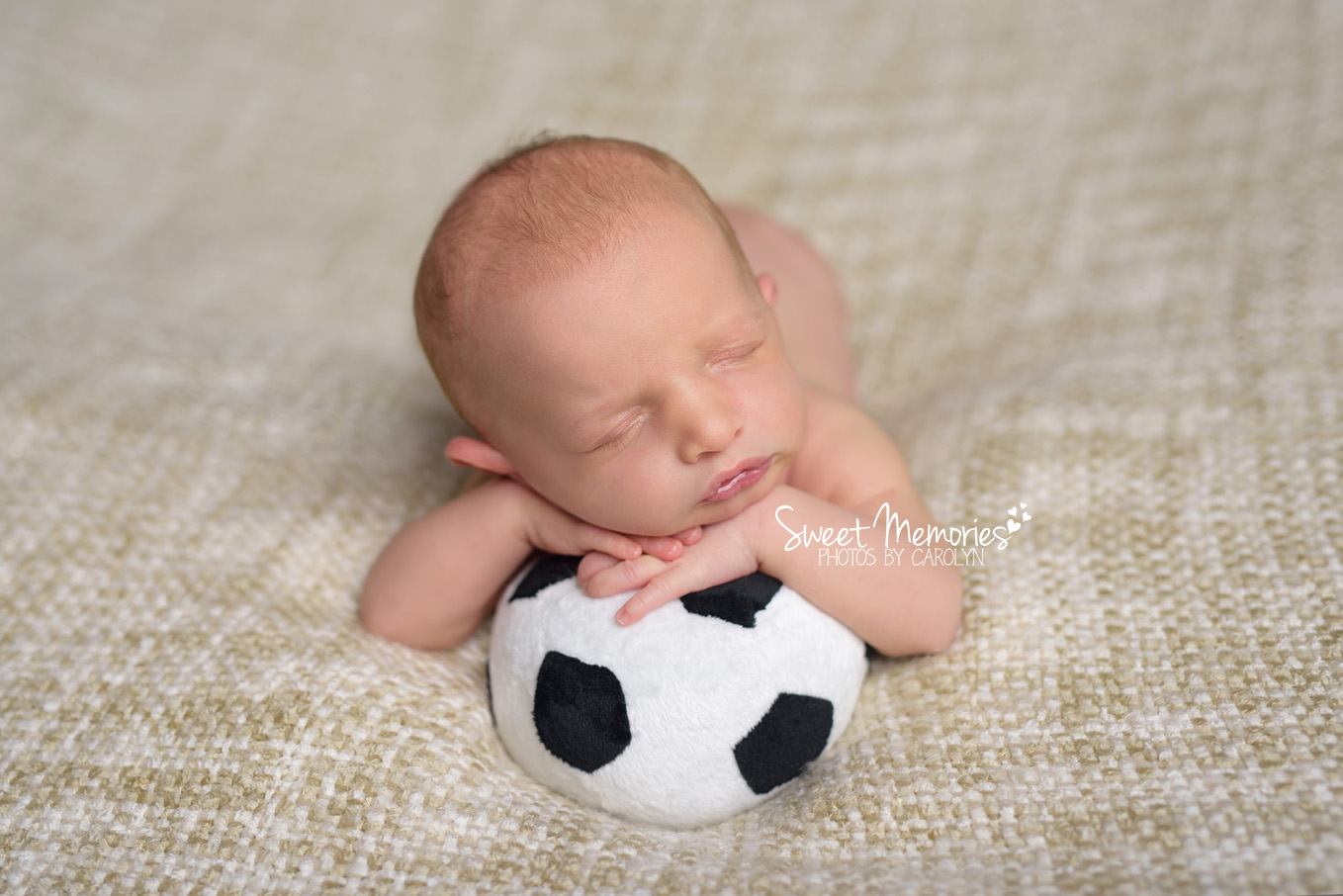 newborn boy with soccer ball