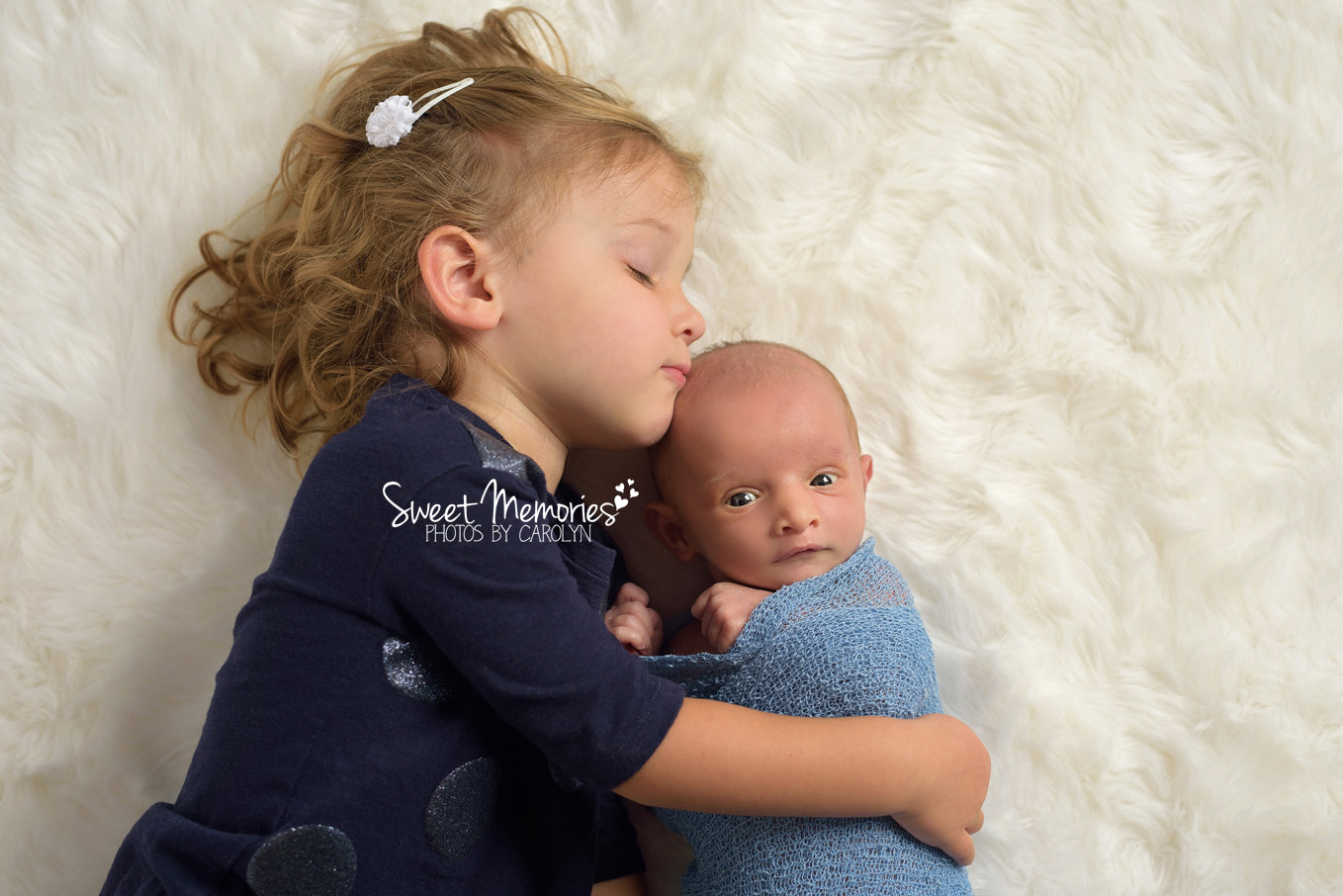 awake newborn boy with big sister