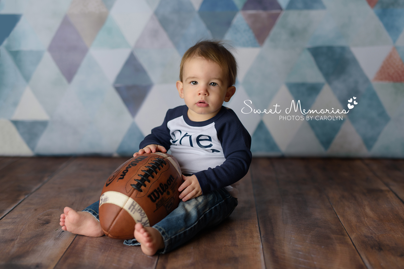 one year old boy with dad's football in Bucks County | Sweet Memories Photos by Carolyn