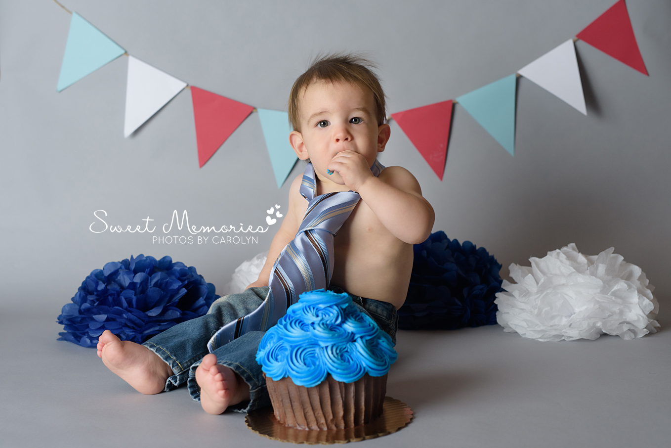 first birthday cake smash of boy wearing dad's tie on gray background  | Sweet Memories Photos by Carolyn