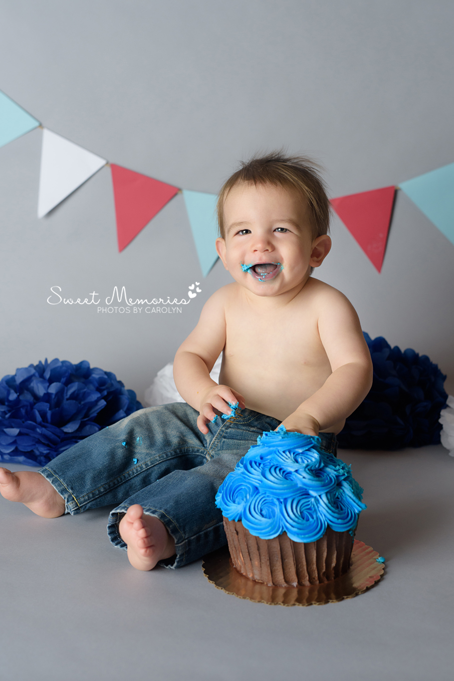 smiling one year old boy cake smash on gray background in Newtown Bucks County PA | Sweet Memories Photos by Carolyn