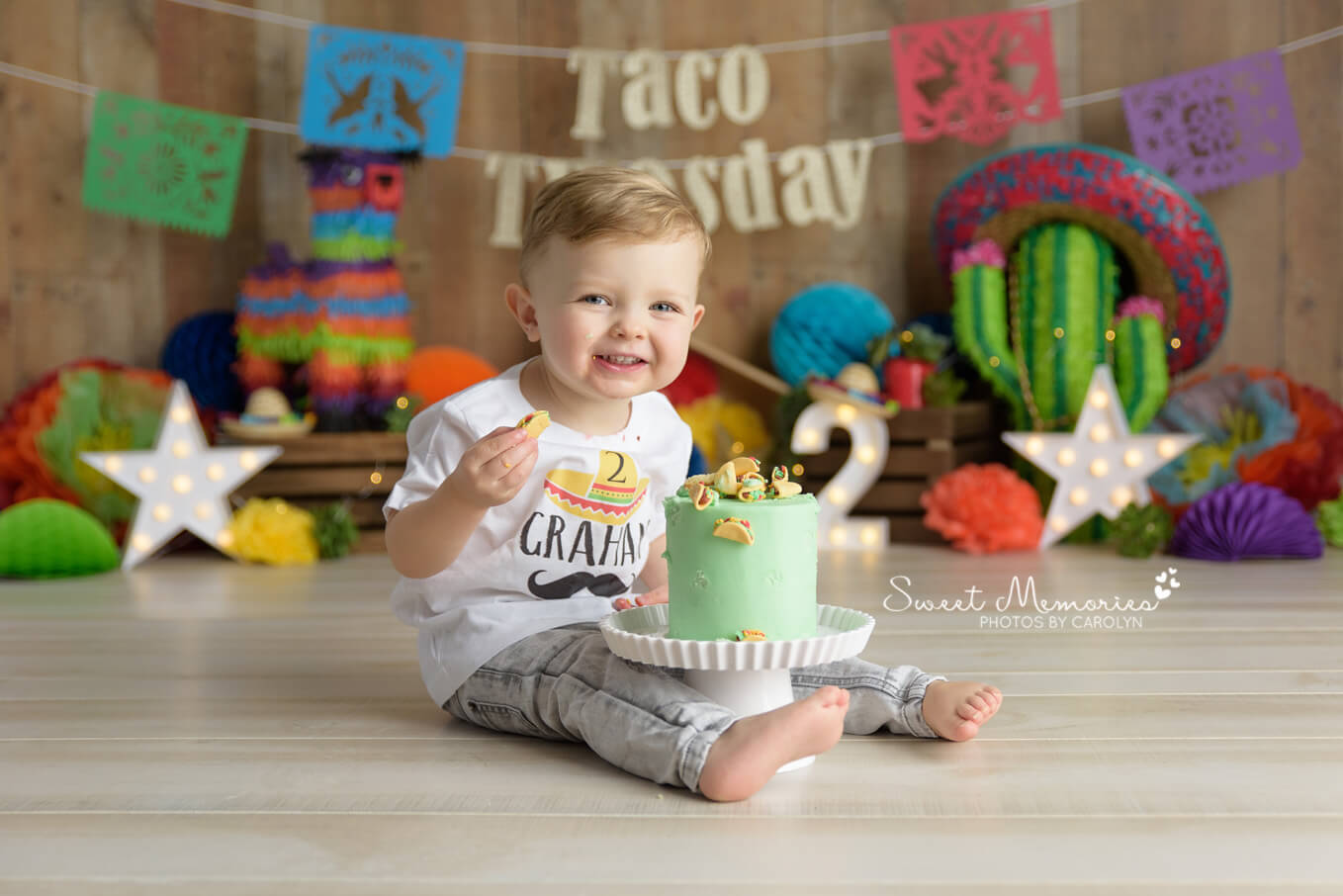 two year old boy eating taco cake