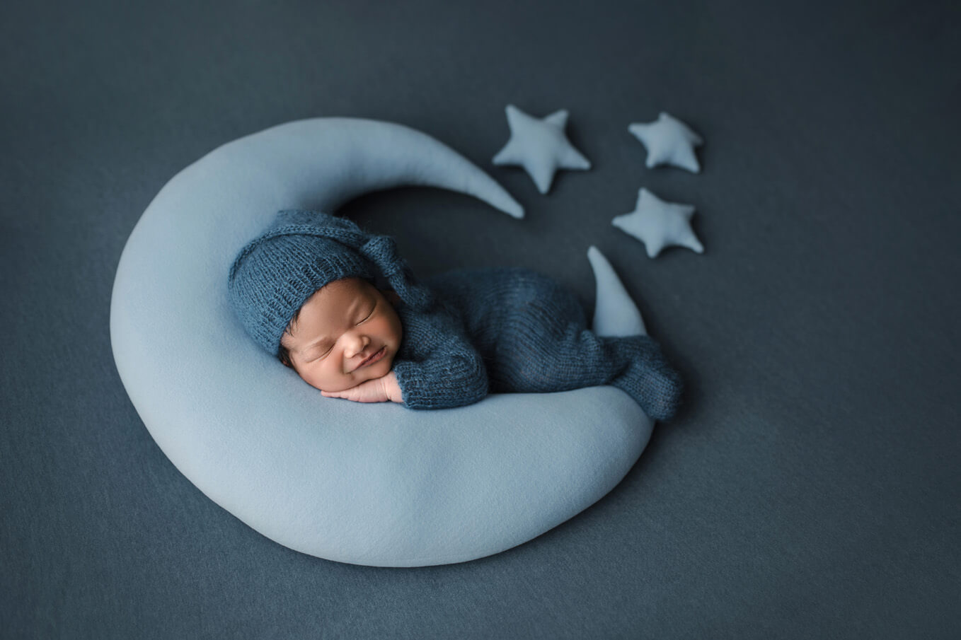 Austin newborn pictures baby on moon prop