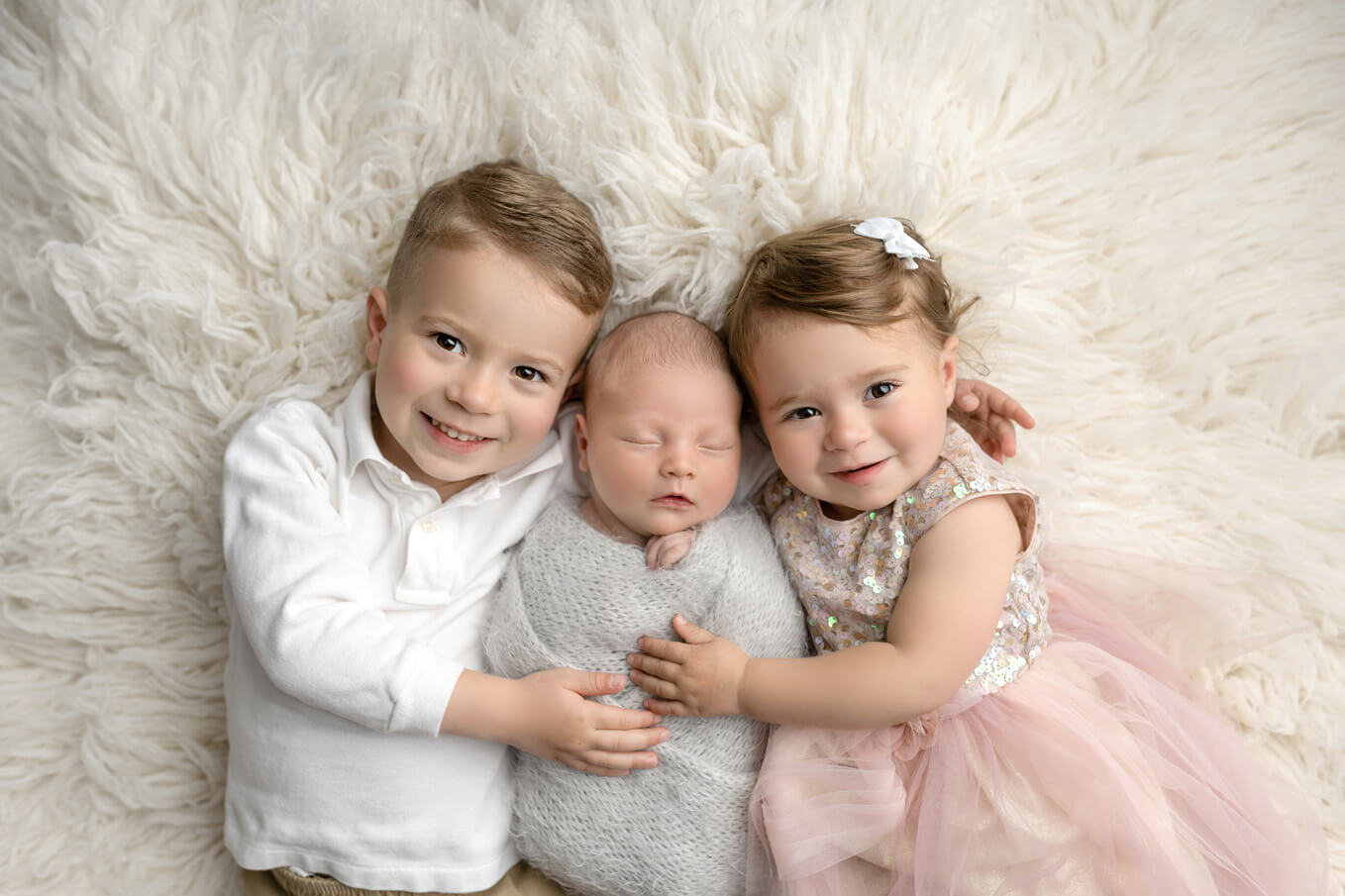 Round Rock Newborn Photographer siblings holding newborn boy