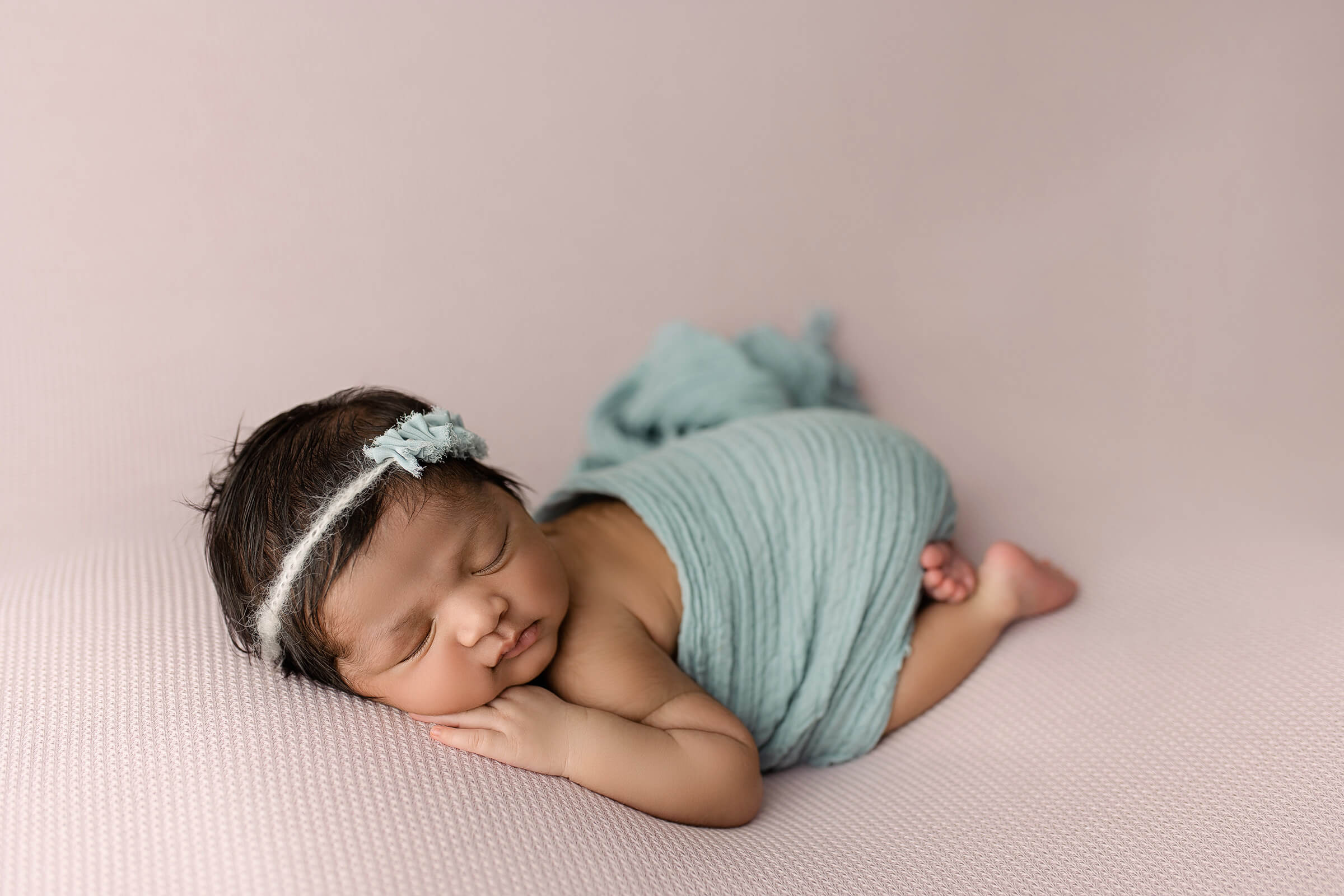 how to choose a newborn photographer Austin baby girl in blue wrap