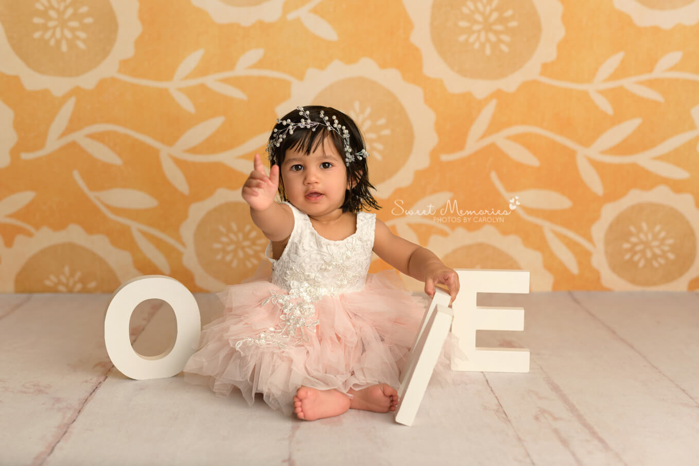 Baby girl with ONE letters with yellow backdrop | First birthday cake smash photography Round Rock TX